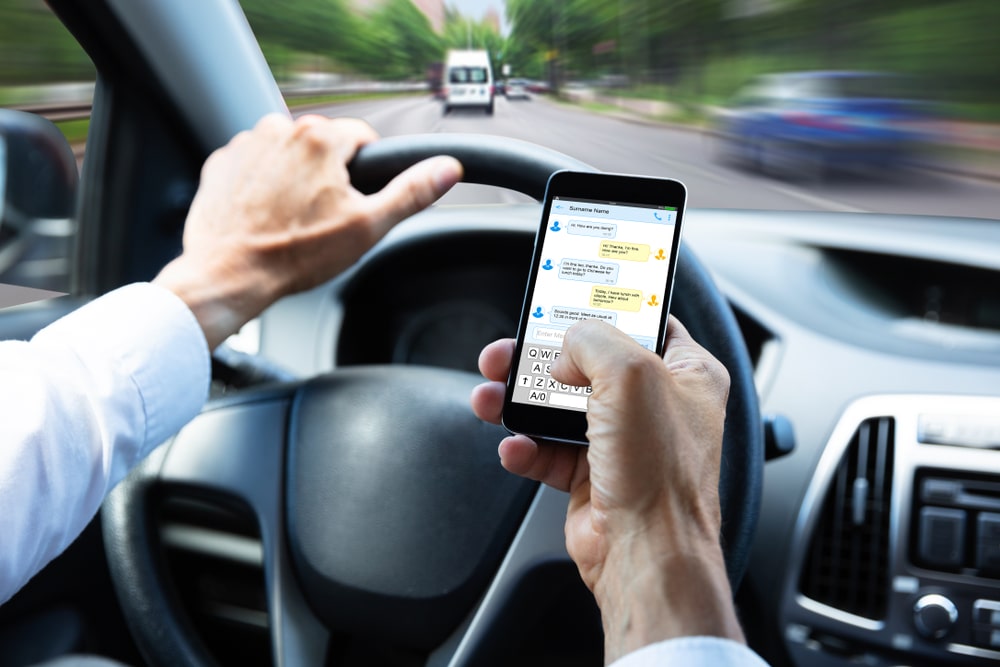 Person Using A Phone While Driving