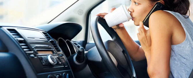 Woman Drinking Coffee, Talking On The Phone And Driving At The Same Time