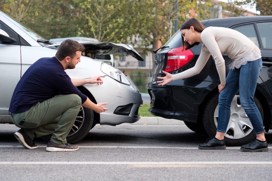 Two Drivers Arguing Next To A Rear End Colision