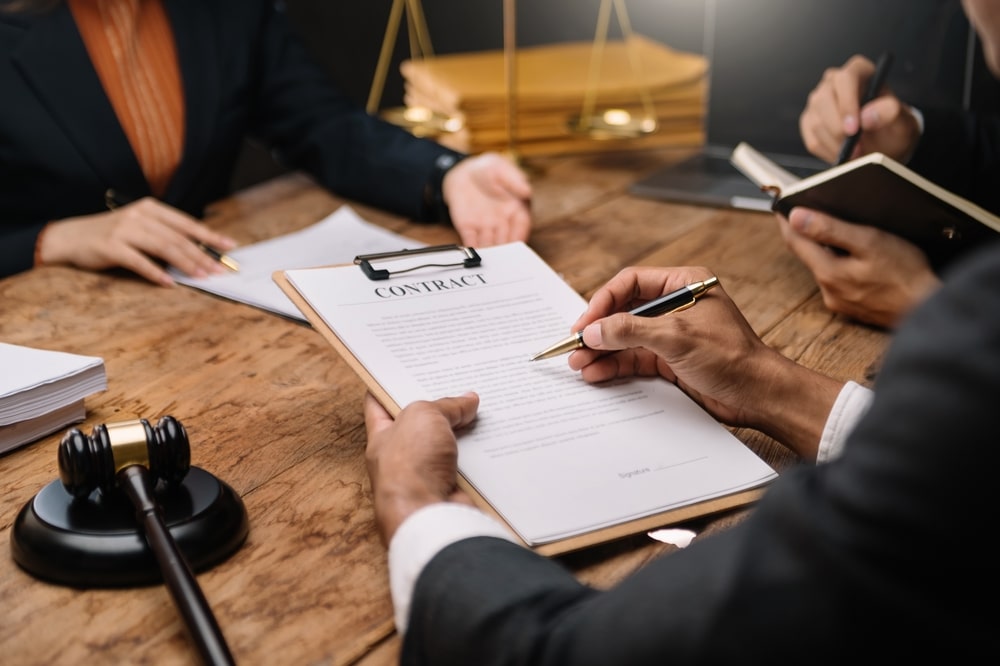 Lawyer And His Client Going Over Documents