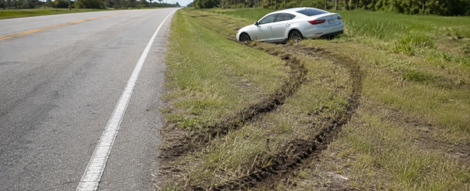 Overcorrection accident claim evidence showing tire tracks leading from a Florida road to an unbranded car